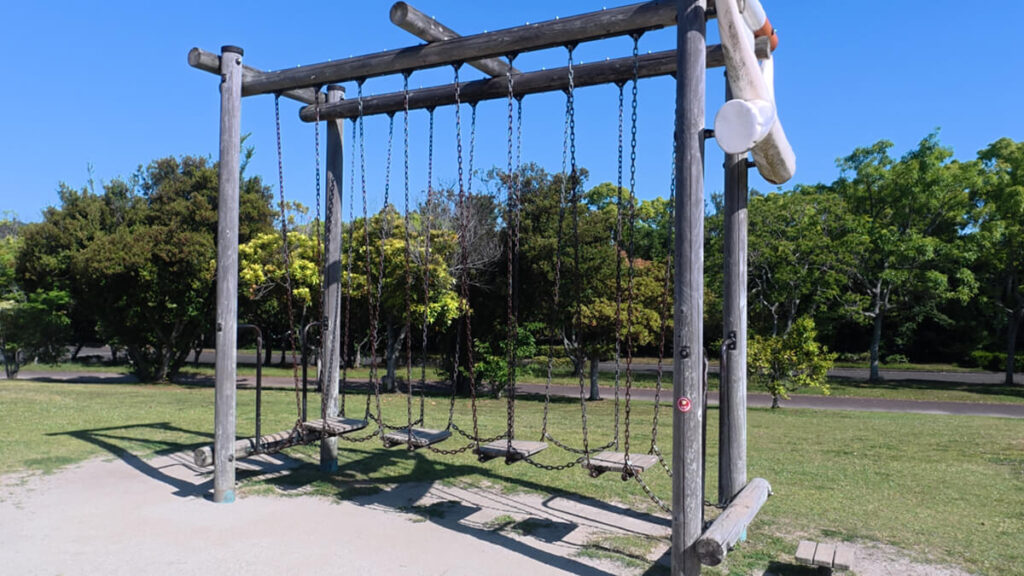 今津運動公園のアスレチック広場にある「バランスアドベンチャー」。チェーンで吊るされた複数枚の木製プレートの上を渡っていくバランス遊具。